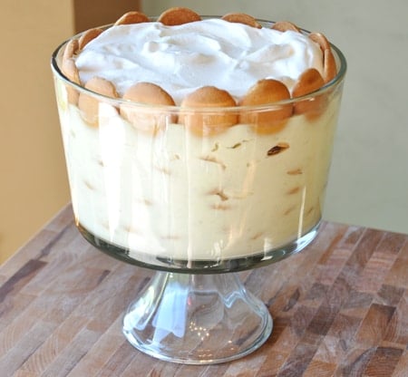 Side view of a glass trifle dish full of banana and Nilla Wafer pudding.