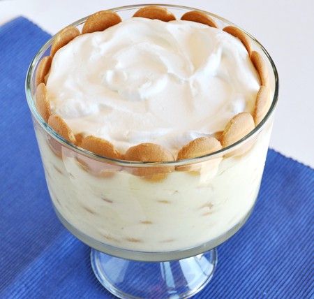 Top view of a trifle dish full of banana pudding and Nilla Wafers on the side.