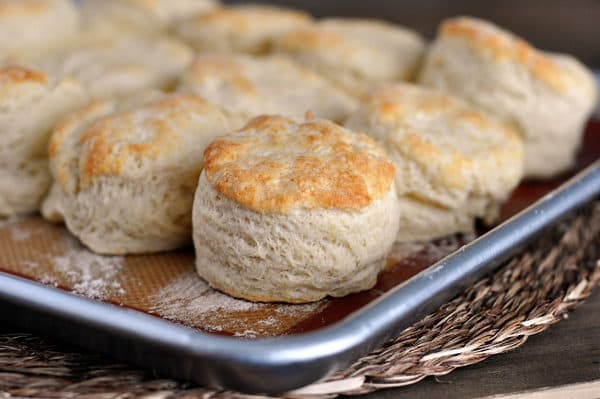 A sheet pan of golden brown cooked biscuits.