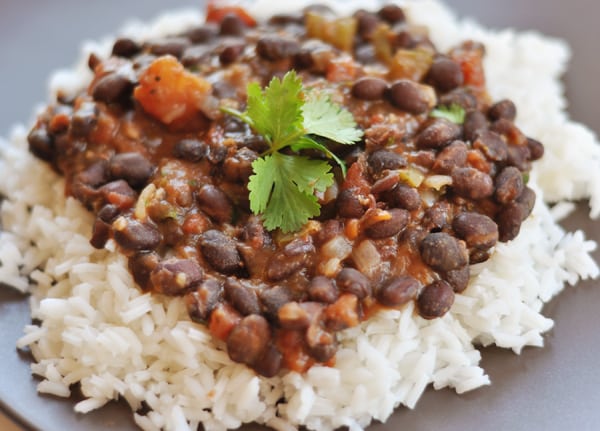 White rice topped with black bean and tomato mixture.