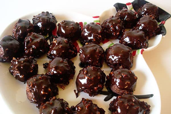 a white platter of chocolate brownie bites with chocolate glaze