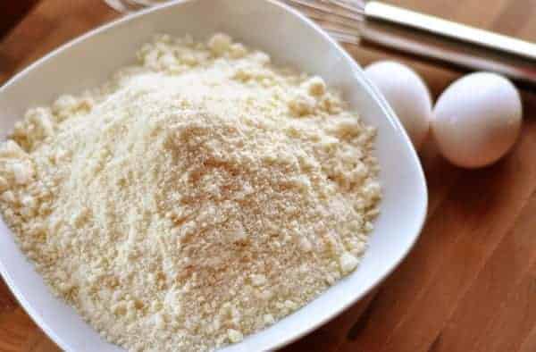 White bowl of yellow dry cake mix.