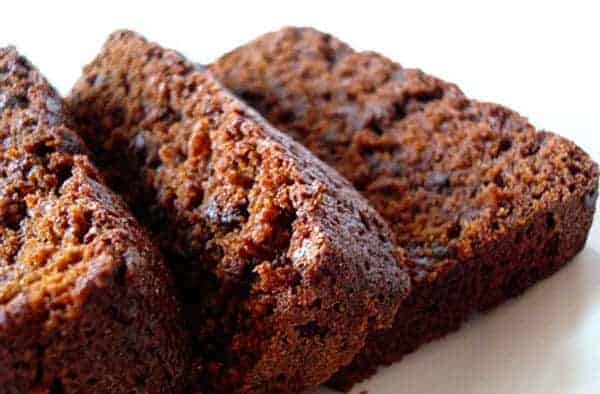 Thick slices of chocolate gingerbread cake on a white plate.