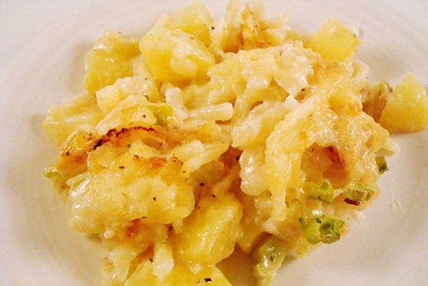 Scoop of potato bake on a white plate.