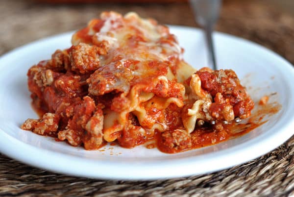 White dish with a large serving of lasagna.