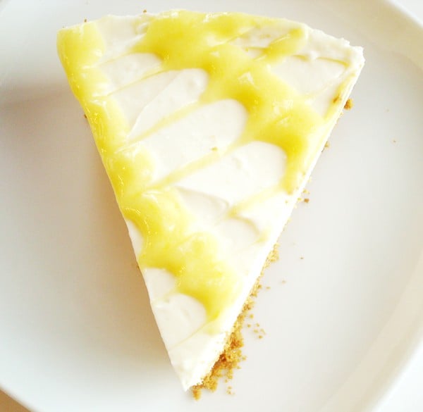 Top view of a slice of lemon cheesecake with lemon curd drizzle on top.