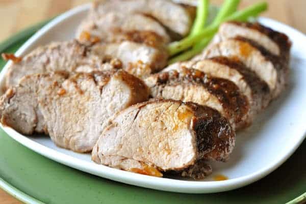 A white plate with thick slices of pork loin.