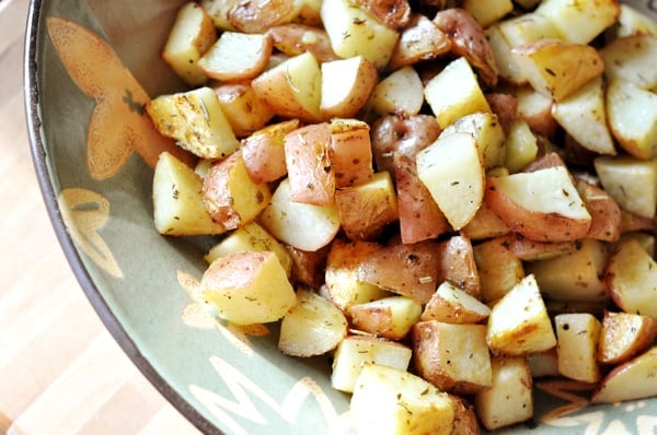 Diced, herb- roasted potatoes in a bowl.