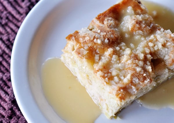 Piece of rhubarb cake with streusel and sauce on top.