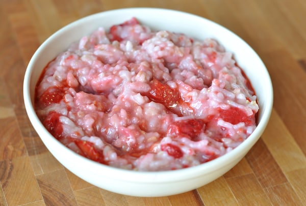 White bowl full of pink, raspberry risotto oatmeal.