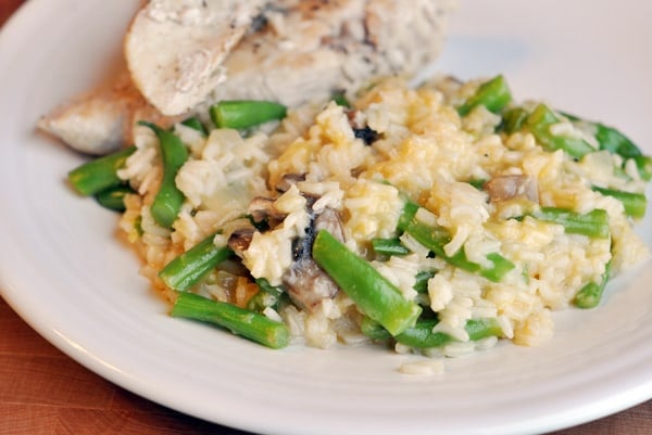 White rice and green beans, with sliced chicken on the side.