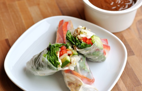 Spring roll cut in half on top of a full spring roll.