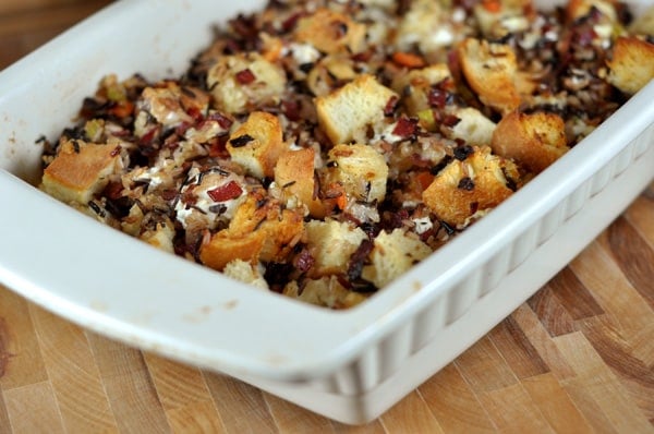 white casserole dish full of goat cheese and wild rice stuffing