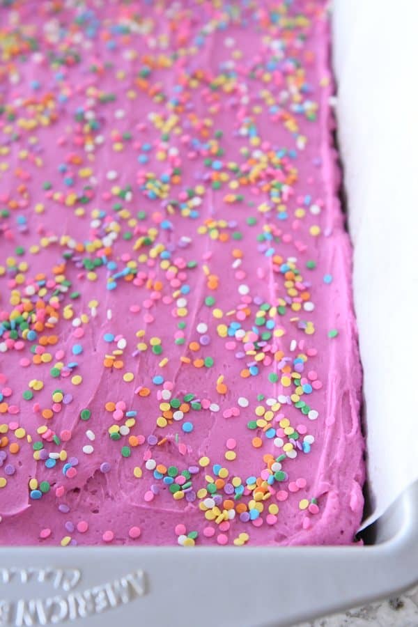 Pan of frosted sugar cookie bars with colorful sprinkles on top.