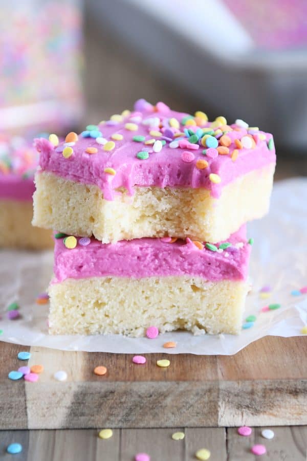 two sugar cookie bars stacked on top of each other with bite taken out
