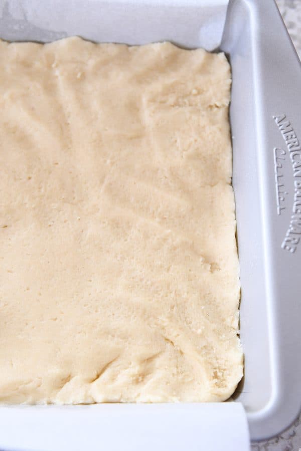 Uncooked dough pressed into metal pan for easy sugar cookie bars.