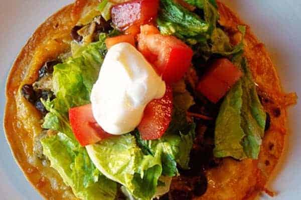 Top view of a tostada with all the toppings.