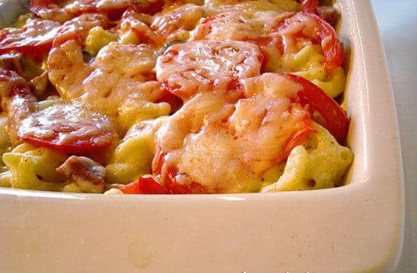 Macaroni and tomato slices baked in a white ceramic dish.