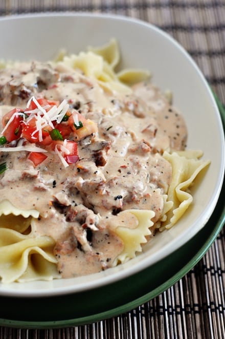 Cooked bowtie pasta topped with creamy tuscan sauce.