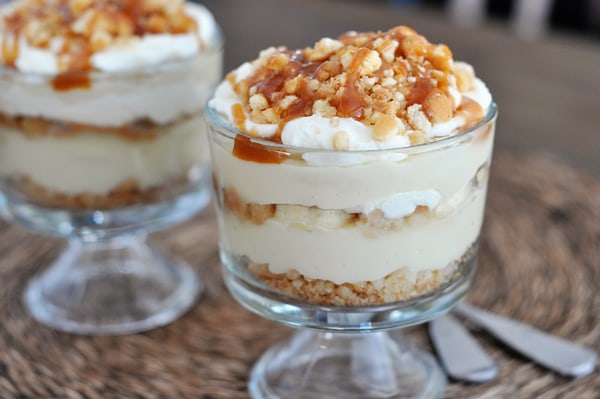 Two mini banana pudding caramel trifles drizzled with caramel.
