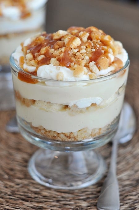 A small banana caramel pudding trifle with drizzled caramel on top.