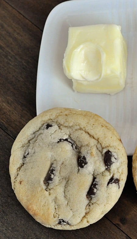 a top view of a chocolate chip cookie and softened butter