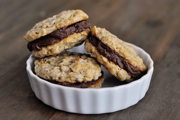 A small white ramekin filled with three fudge filled cookies.