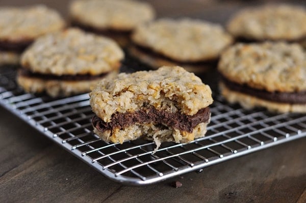 Fudge filled cookies on a cooling rack  with one cookie with a bite taken out of it.