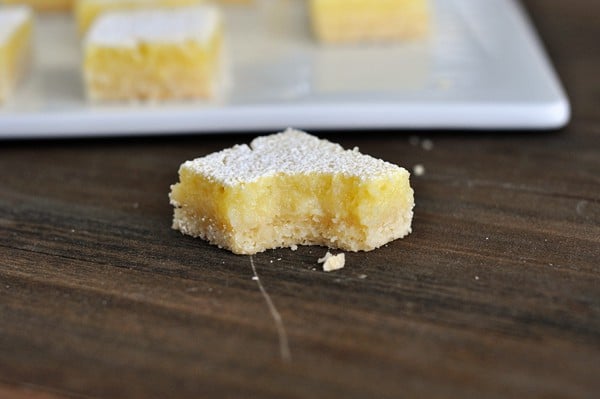 a square of lemon bar with a bite taken out