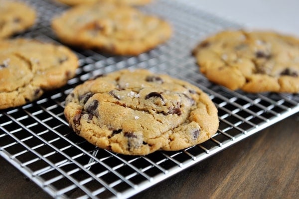 Salted chocolate chip peanut butter cup cookies on a cooling rack.