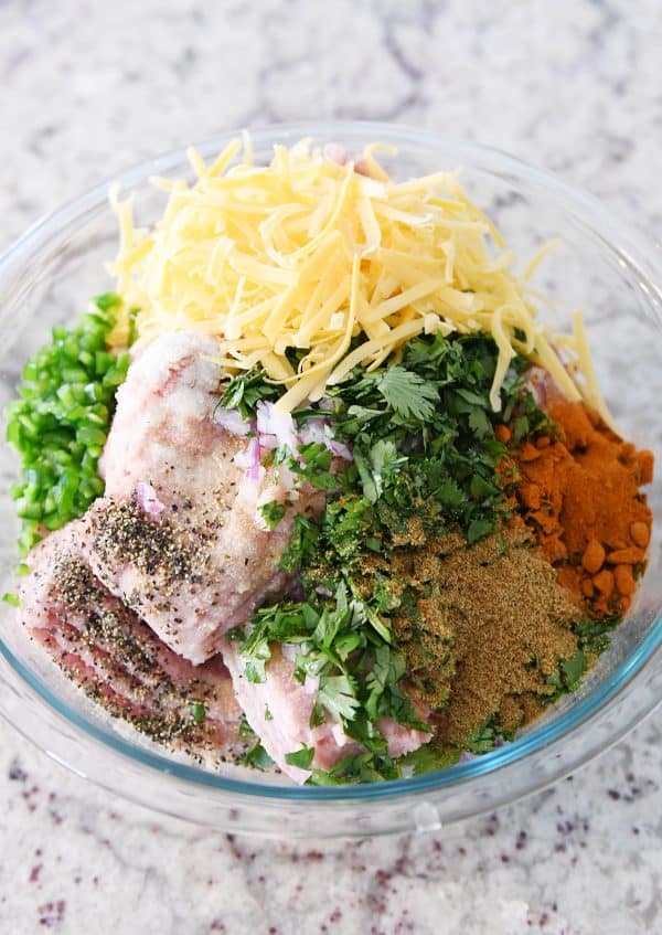 Ingredients for jalapeno cheddar turkey burgers in glass bowl before combining.