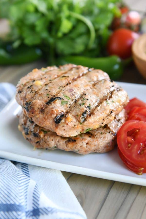 Two jalapeno cheddar turkey burger patties stacked on each other.