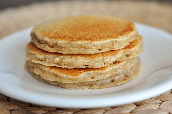 four stacked pancakes on a white plate