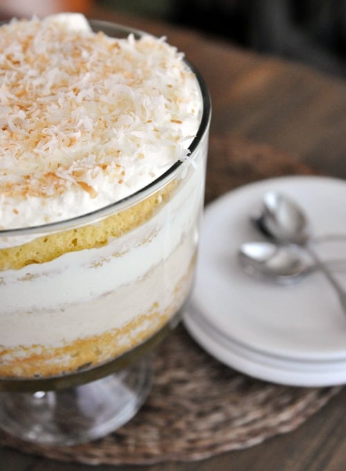A trifle dish full of coconut tres leches trifle topped with toasted coconut.