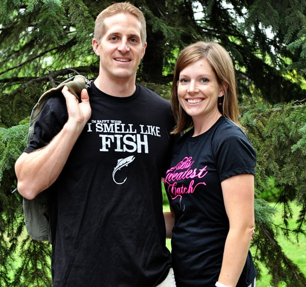 man and woman wearing fish black fish shirts