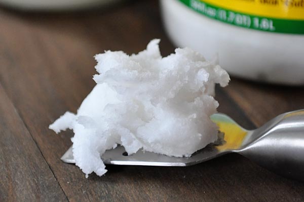 a scoop of solidified coconut oil on a metal spatula