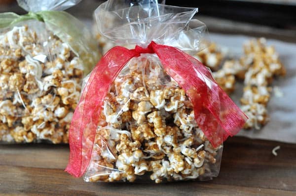 cinnamon roll popcorn in bags with red and green bows tied on top