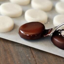 dipping homemade peppermint pattie in chocolate