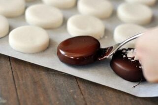 dipping homemade peppermint pattie in chocolate