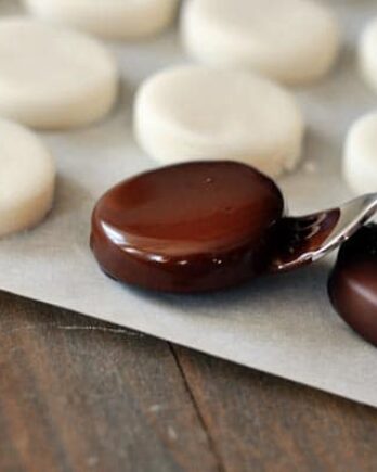 dipping homemade peppermint pattie in chocolate