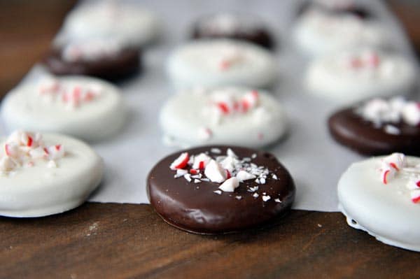 Chocolate and white chocolate dipped cookies with crushed candy canes on top.