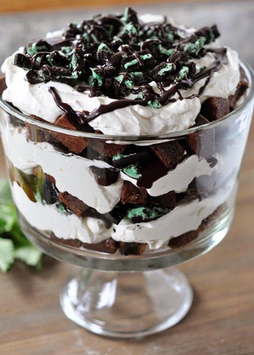 Trifle dish full of a mint brownie Oreo trifle topped with crushed Oreo's.