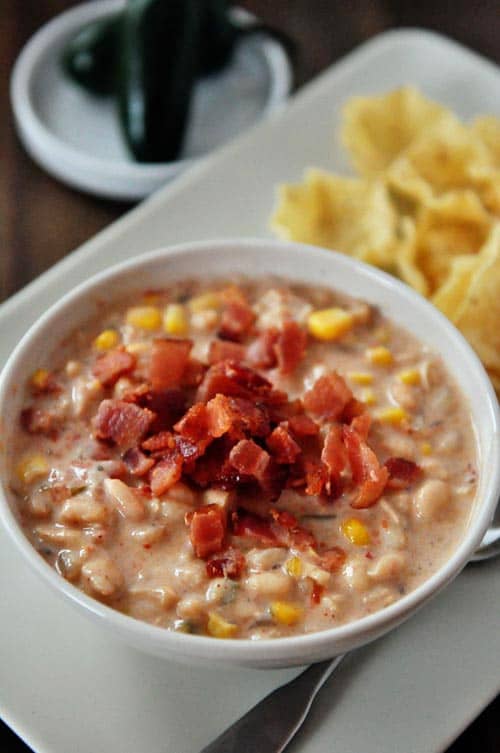 top view of a jalapeno white bean chili with chopped bacon on top