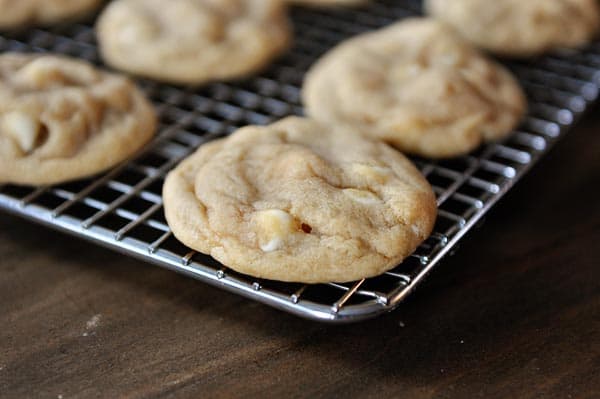 White chocolate macadamia nut cookies on a cooling rack.