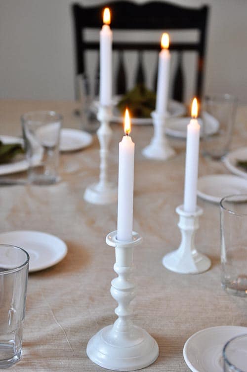 white candles on a nicely set table