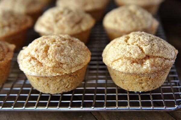 Cinnamon and sugar dusted muffins on a cooling rack.