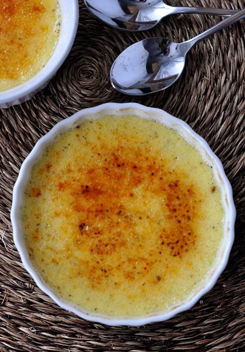 Top view of a white ramekin with a torched creme brûlée.