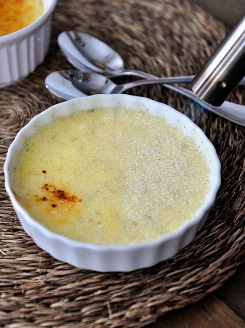 Top view of a white ramekin of creme brûlée before it's been torched.