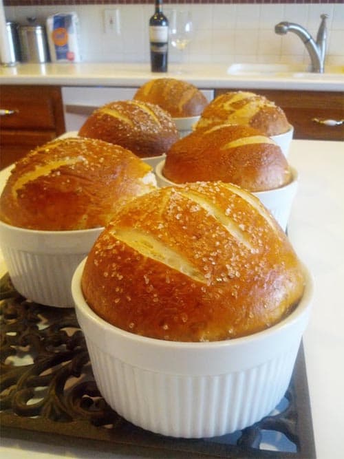 baked pretzel rolls inside white ramekins