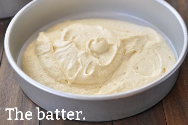 Yellow uncooked cake batter in a cake pan.